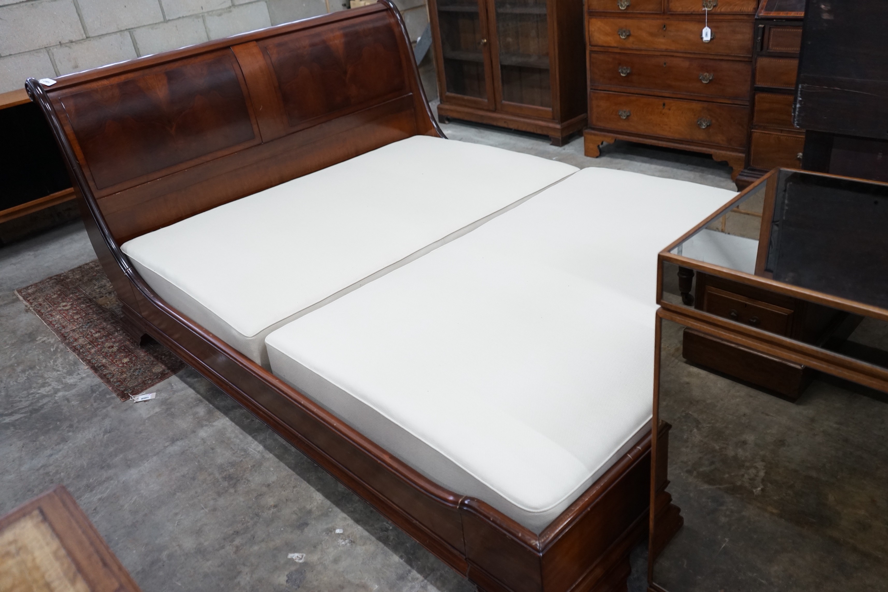 An 'And So To Bed' mahogany kingsize sleigh bed with Prestige two section divan base, width 161cms, length 224cms, height 100cms